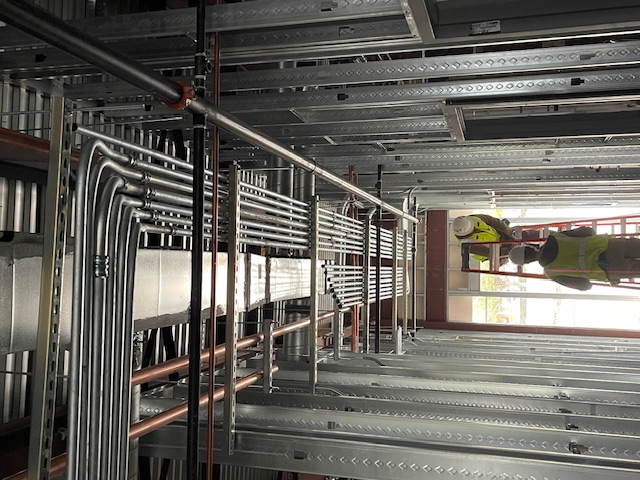 Professional electrical panel installation with conduit work