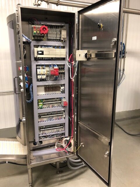 Professional electrical control panel with organized wiring and safety systems